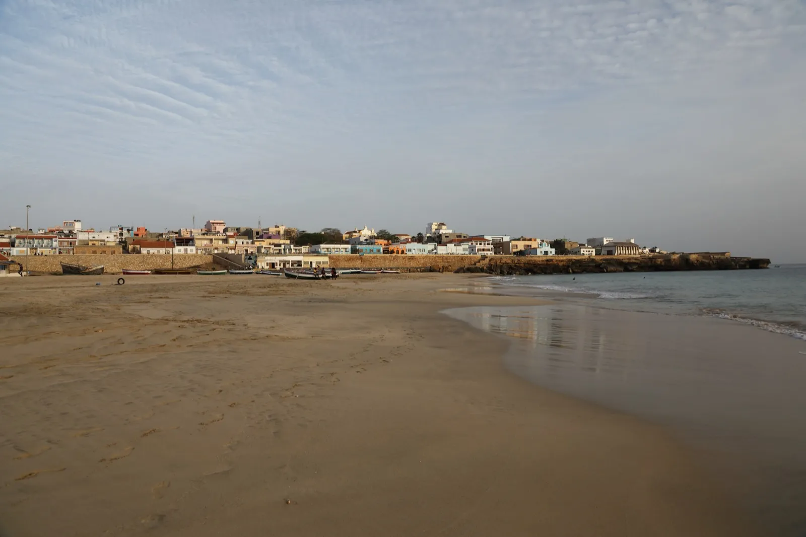 Quiet beach and pastel seafront houses of Porto Inglês, Vila do Maio, in early light