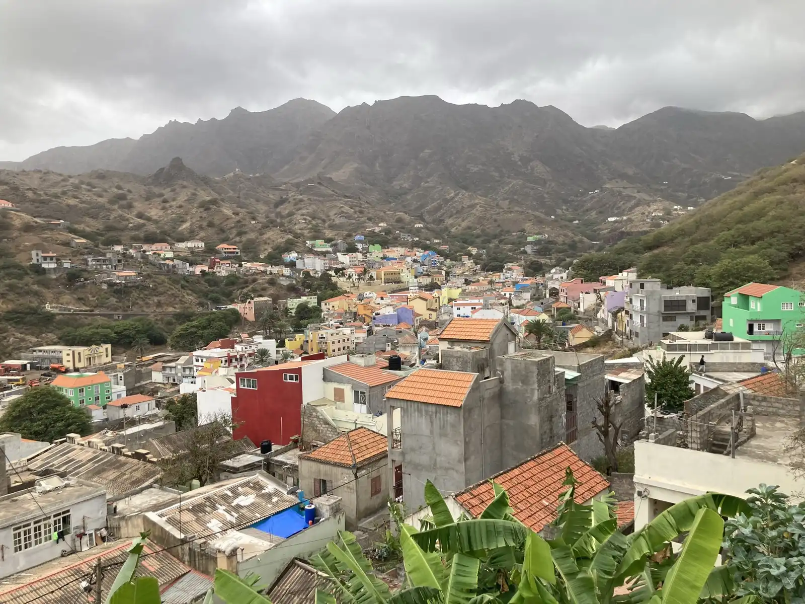Colourful houses of Ribeira Brava filling its valley below the Monte Gordo massif, São Nicolau